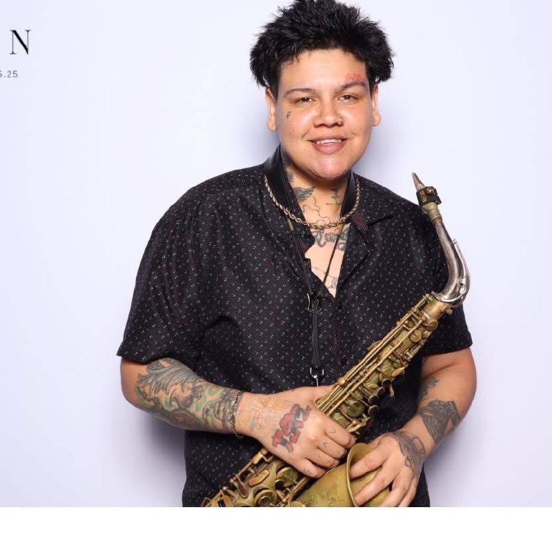 Live saxophonist holding an alto saxophone